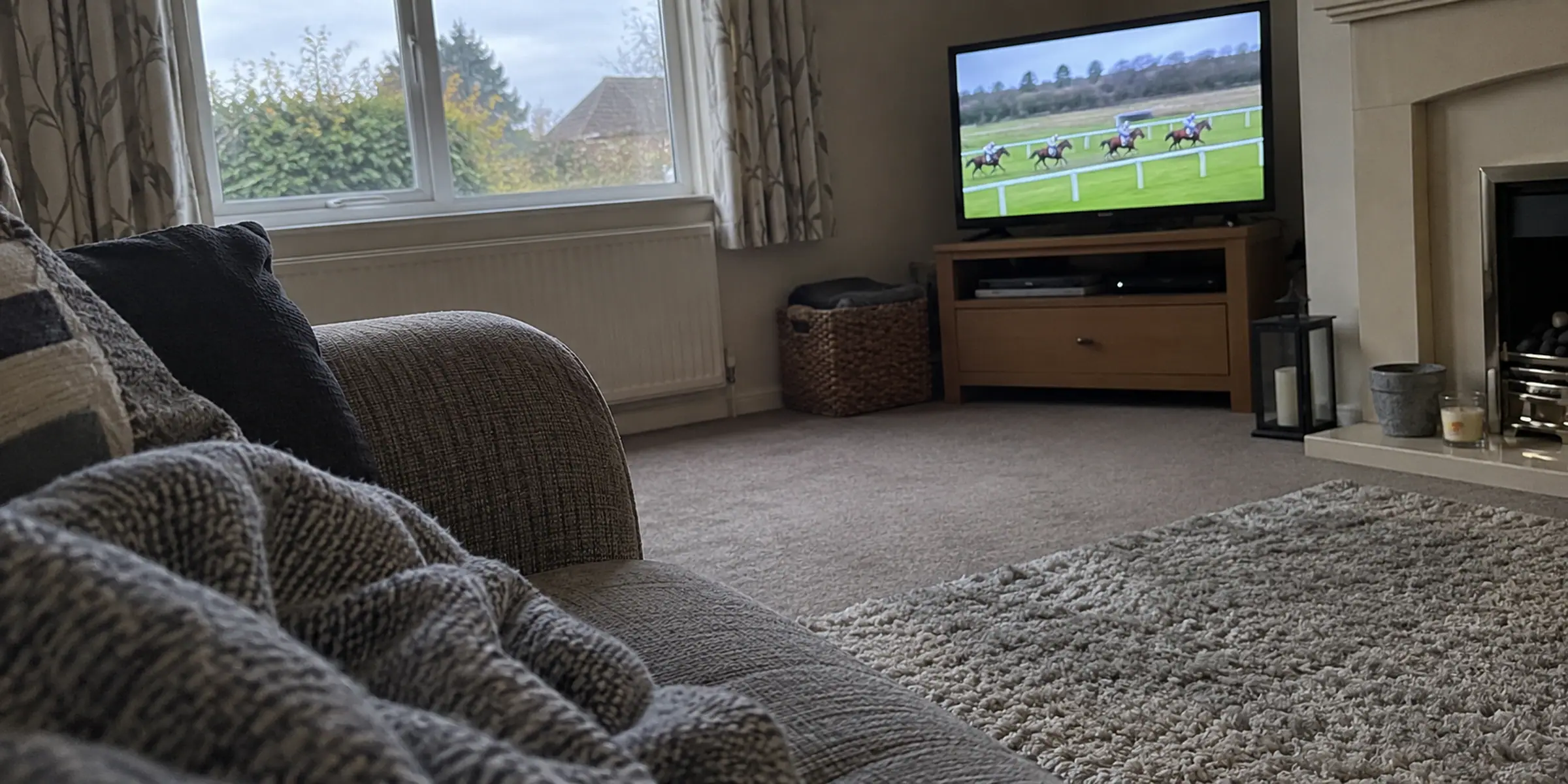 Racing on a small television seen past the arm of a sofa