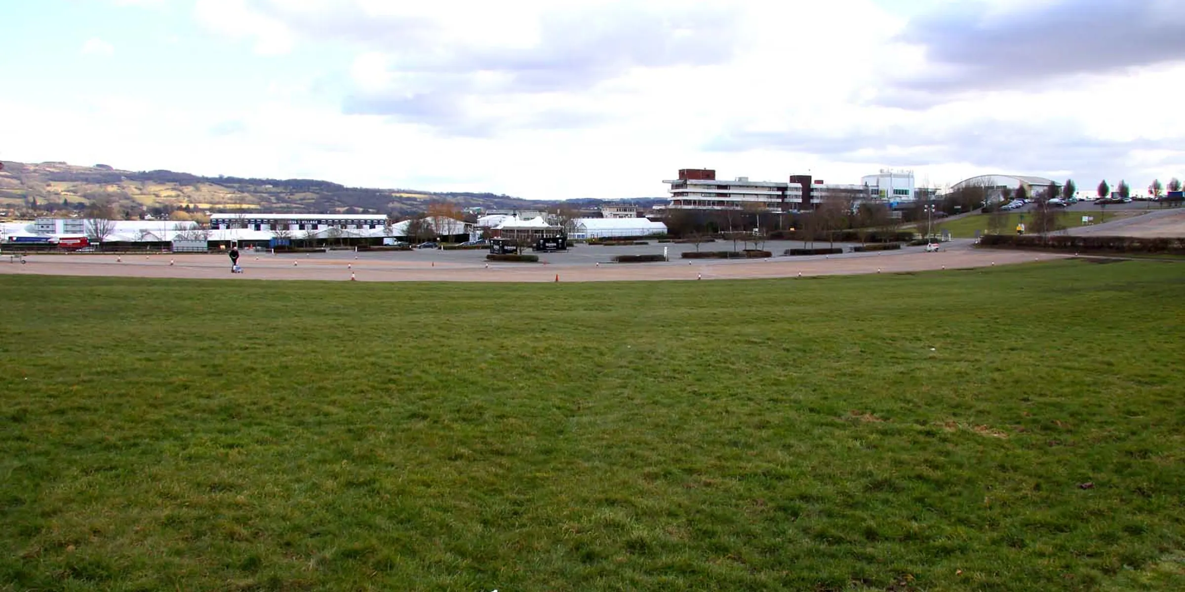 The open turf at Cheltenham with the stands across the far side