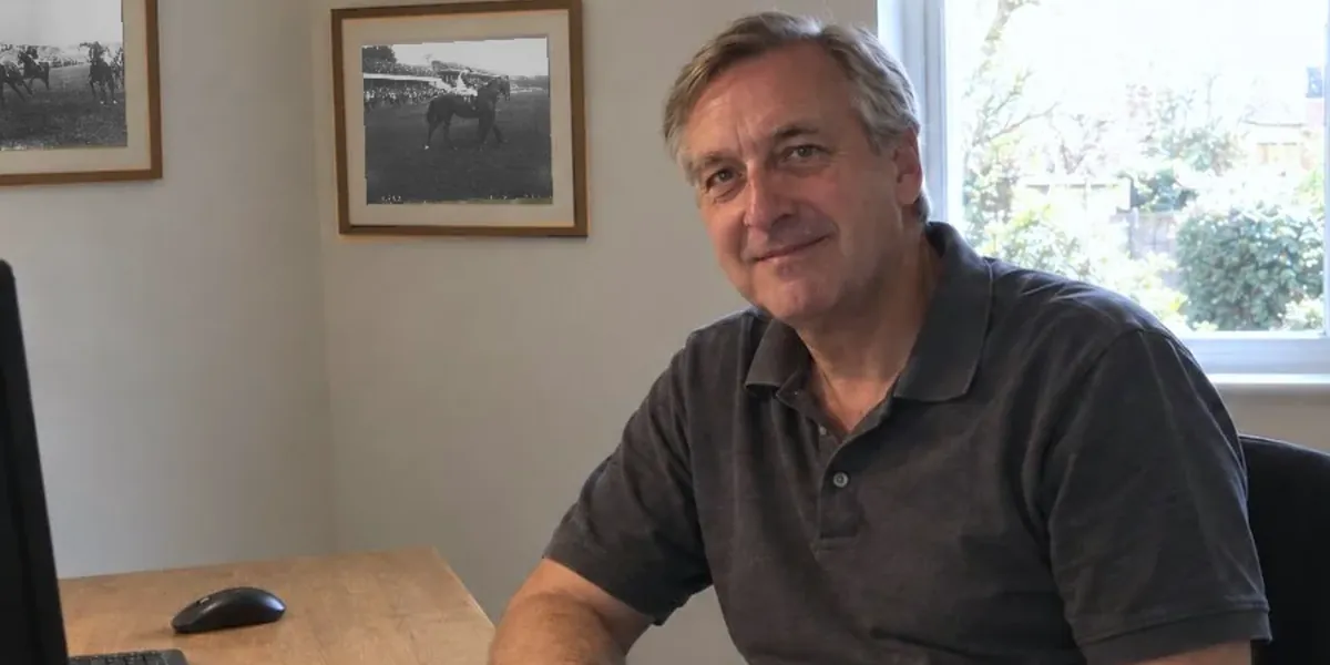 Lee seated at his desk